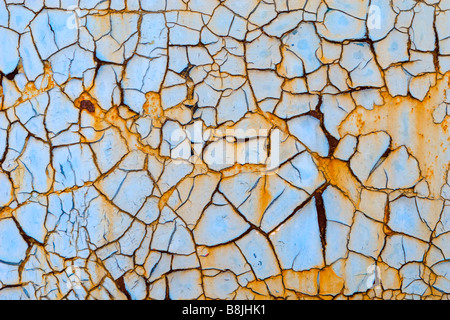 Closeup of blue metal sheet covering with net of peeling off paint. Stock Photo