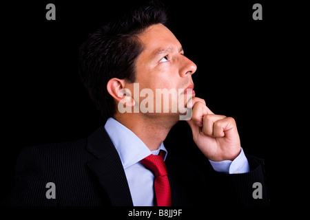businessman thinking looking to the copyspace isolated on black Stock Photo