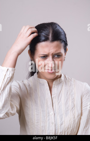 Woman scratching head Stock Photo