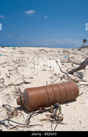 Plastic trash washed ashore on the white sand beach near Tulum Mexico. Stock Photo
