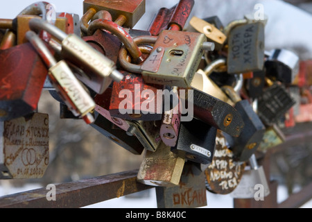 Closeup of many locked padlocks attached to each other according to wedding tradition. Stock Photo