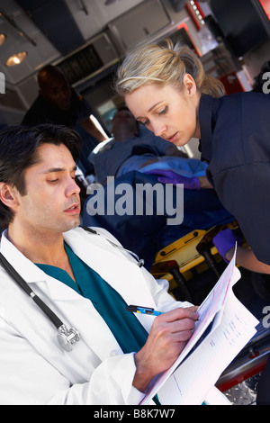 Paramedic advising doctor about arriving patient Stock Photo