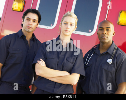 Portrait of paramedics standing in front of an ambulance Stock Photo