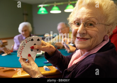 Senior adults playing bridge Stock Photo