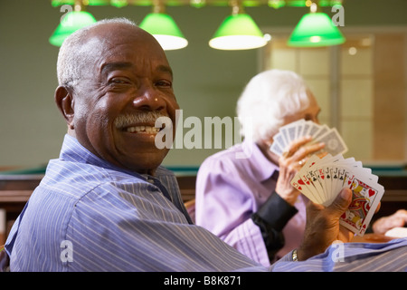 Senior man playing bridge Stock Photo