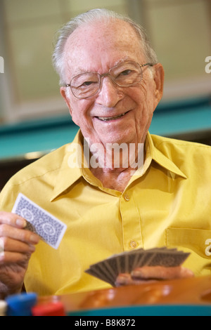 Senior man playing bridge Stock Photo