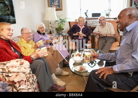 Senior adults having morning tea together Stock Photo