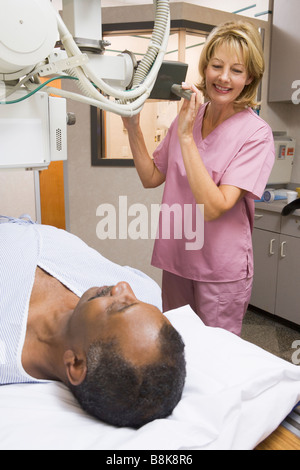 Nurse With Patient Having An X-Ray Stock Photo