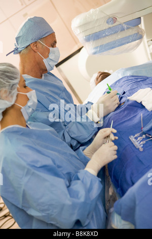 Surgeons Operating On Patient Stock Photo