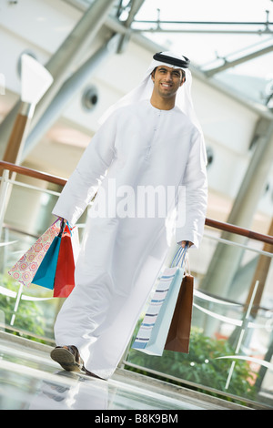 Man walking in mall smiling (selective focus) Stock Photo