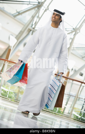 Man walking in mall smiling (selective focus) Stock Photo