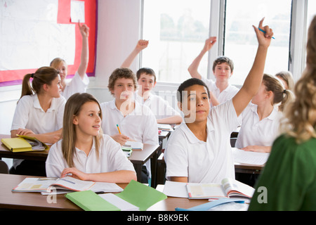 Secondary school students in a classroom answering questions Stock Photo