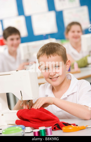 Male student using sewing machine Stock Photo
