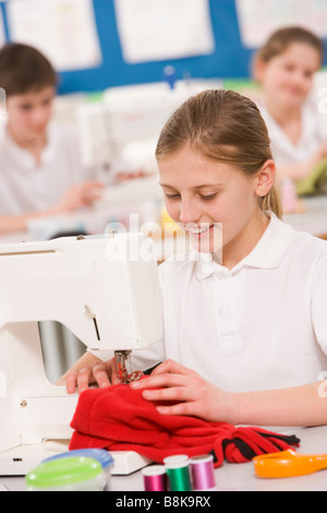 Female student using sewing machine Stock Photo