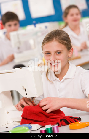 Female student using sewing machine Stock Photo