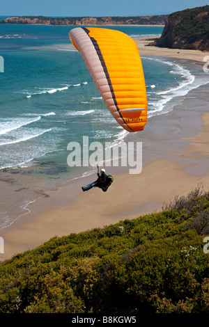 A Paraglider gliding over the Famous Cliffs of Bells beach Torquay Victoria Australia. Stock Photo