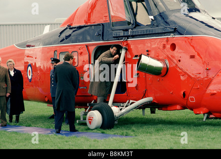 Prince Charles gets back into his Sea King helecopter after visiting people displaced by floods at Towyn, North Wales. Stock Photo