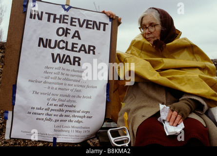 Greenham Berkshire UK 13 December 1982: A woman protester with her banner at the Greenham Common Women's Peace Camp. Stock Photo