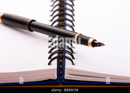 pen over a empty notepad selective focus Stock Photo