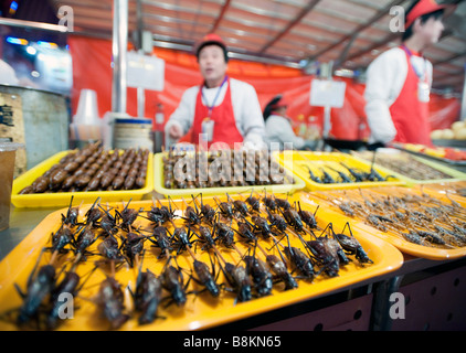 Vendors at a food stall in Donghuamen street night food market in Beijing 2009 Stock Photo