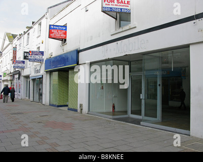 Empty closed down shop units in a desolate part of Worthing shopping centre due to the credit crunch Stock Photo