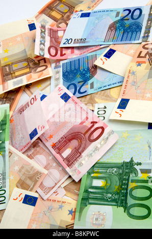 Collection of various euro banknotes displayed on a surface in a ...