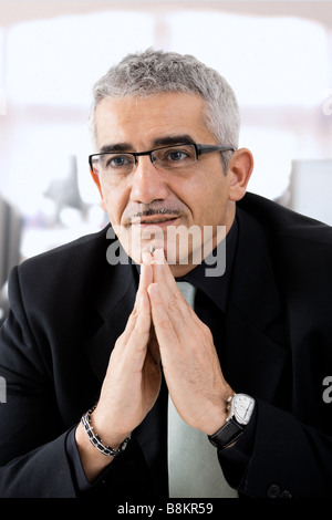 Mature gray haired creative looking businessman thinking Stock Photo