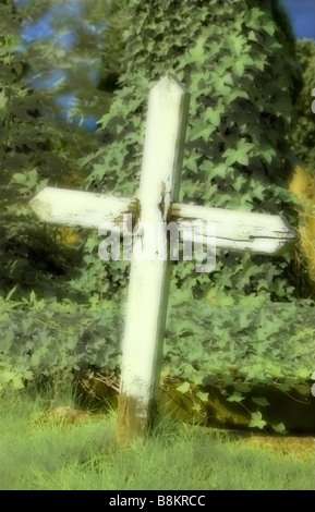 White wooden cross in graveyard Stock Photo