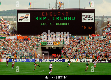 West Germany Football fans stand watching a football game between England and the Republic of Ireland Stock Photo