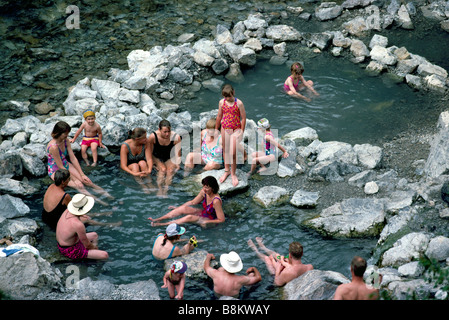 People soaking in Lussier Hot Springs beside the Lussier River in Whiteswan Lake Provincial Park British Columbia Canada Stock Photo