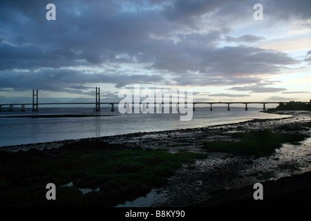 The new Severn Bridge inaugurated in 1996, seen from the Welsh side of the River Severn near Portskewett, Monmouthshire. Sunset Stock Photo