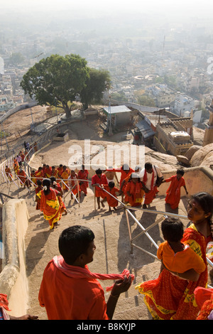 India Tamil Nadu Tiruchirappalli Rock Fort Temple red clad pilgrims climbing steps up to hilltop shrine Stock Photo