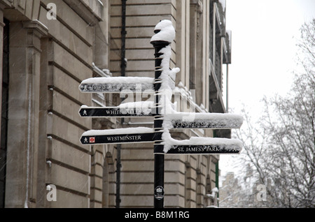 An ice & snow covered direction pole leading to Parliament Square, London during the snow storm of 2nd February 2009. Stock Photo
