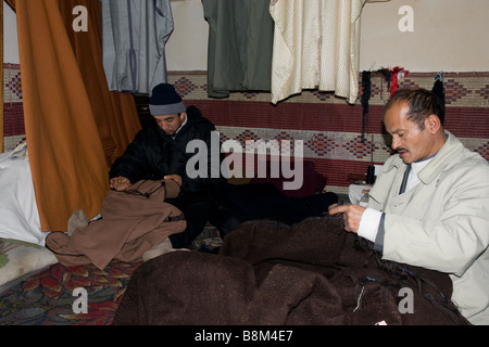 Seated crosslegged, tailors work in their tinyu shop in Testour, a village west of Tunis Stock Photo