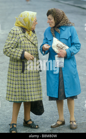 Old women chatting in street just back from the shops. Blackhill Estate,  Glasgow Scotland Uk 1985. 1980s HOMER SYKES Stock Photo