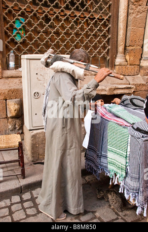 A workman looks at merchandise in Cairo's Khan el-Khalili market