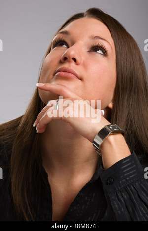 Portrait of young woman looking up Stock Photo