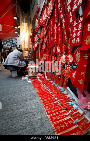 A calligrapher prepares lucky bans for the Lunar/Chinese New Year in Wanchai, Hong Kong. Stock Photo