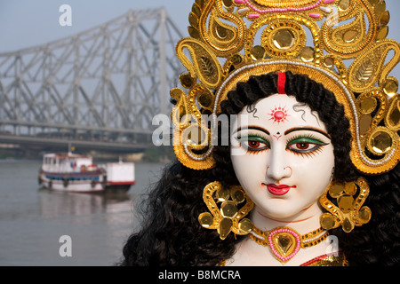 Goddess Saraswati with Calcutta's Howrah Bridge in the background, India Stock Photo