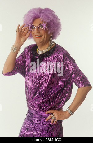 Dame Edna Everage Barry Humphries actor comedian and female impersonator wearing sparkling purple glasses and matching dress 1980s UK HOMER SYKES Stock Photo