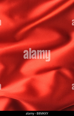 red satin background A satiny fabric with beautiful light shadow waves Stock Photo