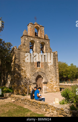 Two college art students drawing in front of Mission Espada, San Antonio Texas tx Missions National Park Stock Photo