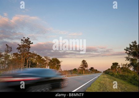 Everglades, Florida. Speeding car at sunset on Tamiami Trail (US 41) in Big Cypress National Preserve, Florida Everglades, USA Stock Photo