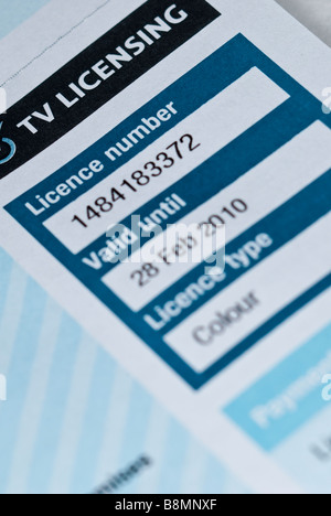 A close up of a uk tv television licence showing the issue number and expiry date