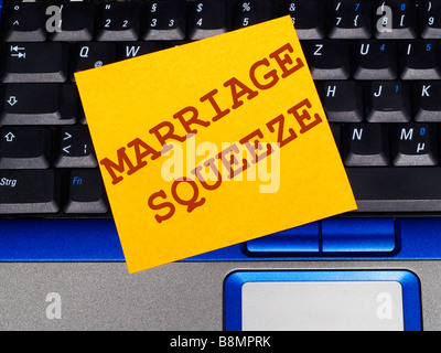 memo note on notebook, marriage squeeze Stock Photo