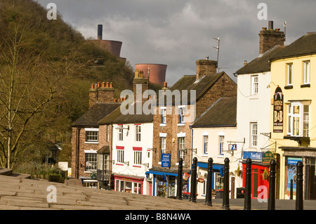Main Street through Ironbridge Shropshire with Power Station Cooling Towers in background Stock Photo