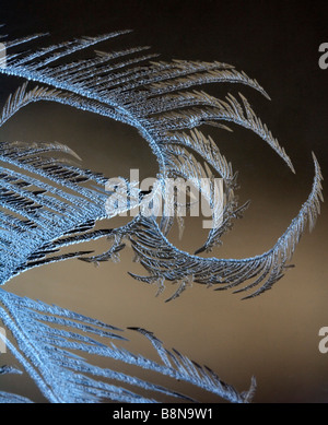 Frost forms on a frigid winter window. Stock Photo