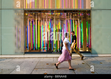 Pedestrians walking past the Louis Vuitton store on 5th avenue Stock Photo  - Alamy