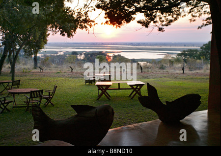 A view of the setting sun over the Chobe river from the Chobe Chilwero Lodge Stock Photo