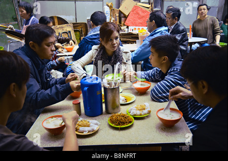 Lunch at a dai pai dong an open air food stall near Stanley Street Hong Kong s Central district Stock Photo